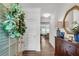 Bright foyer with wood floors, decorative mirror, and a glimpse into the open-concept living space at 218 Jordan Dr, Woodstock, GA 30188