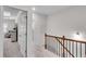 Bright upstairs hallway featuring carpet flooring and access to multiple rooms at 218 Jordan Dr, Woodstock, GA 30188