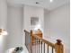 Well-lit hallway with wooden railing, a small desk and view of the floor below at 218 Jordan Dr, Woodstock, GA 30188