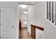 Hallway with wood-look floors, staircase, and modern sliding door leading to other living spaces at 218 Jordan Dr, Woodstock, GA 30188