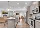 Open kitchen with granite countertops, stainless appliances, leading into dining and living spaces at 218 Jordan Dr, Woodstock, GA 30188
