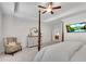 Bright main bedroom featuring a four-poster bed, ceiling fan, TV, and elegant furnishings at 218 Jordan Dr, Woodstock, GA 30188