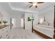 Bright main bedroom featuring a four-poster bed, tray ceiling, and plush carpeting at 218 Jordan Dr, Woodstock, GA 30188