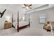 Spacious main bedroom with ceiling fan, four-poster bed, carpeting, and natural light at 218 Jordan Dr, Woodstock, GA 30188