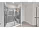Bathroom shower featuring sleek glass enclosure, bench seat and neutral tiling at 218 Jordan Dr, Woodstock, GA 30188