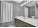 Bright bathroom featuring a single sink vanity, framed mirror, and a white shower curtain at 260 Lamplighter Se Ln, Marietta, GA 30067