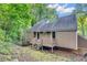 Back of the house with a wooden porch and siding among the trees at 260 Lamplighter Se Ln, Marietta, GA 30067