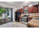 Efficient kitchen with stainless steel appliances, dark cabinets, and access to the backyard at 260 Lamplighter Se Ln, Marietta, GA 30067