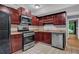 Efficient kitchen with stainless steel appliances, dark cabinets, and tiled floors at 260 Lamplighter Se Ln, Marietta, GA 30067