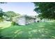 Large backyard showcasing well-maintained lawn, trees and stone patio area at 2628 Hickory Trl, Snellville, GA 30078