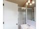 Clean bathroom featuring a tiled shower with glass doors and a sink with a white cabinet at 2628 Hickory Trl, Snellville, GA 30078