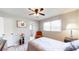 Inviting bedroom with wood-look flooring, natural light, and a stylish orange chair at 2628 Hickory Trl, Snellville, GA 30078