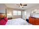 Bedroom featuring a floral patterned bed, wood furniture, and a ceiling fan at 2628 Hickory Trl, Snellville, GA 30078