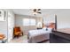Comfortable bedroom with wood-look floors, ceiling fan, and a quaint orange chair at 2628 Hickory Trl, Snellville, GA 30078