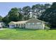 Inviting brick home with a covered front porch and a well-manicured lawn, surrounded by mature trees at 2628 Hickory Trl, Snellville, GA 30078