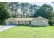 Charming brick ranch-style home with an attached carport and a well-maintained front lawn at 2628 Hickory Trl, Snellville, GA 30078