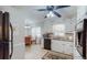 Well-lit kitchen featuring white cabinetry, granite countertops, and a dining area at 2628 Hickory Trl, Snellville, GA 30078