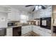 Well-lit kitchen featuring white cabinetry, granite countertops, and modern appliances at 2628 Hickory Trl, Snellville, GA 30078