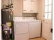 Functional laundry area with a washer, dryer, and a water heater, providing essential household services at 2628 Hickory Trl, Snellville, GA 30078