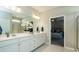 Contemporary bathroom with double sinks, quartz counters and a stand up shower with glass doors at 655 Blackshear Trl, Temple, GA 30179