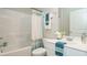 Bright bathroom featuring a shower-tub combo with shower curtain and a white vanity with ample counter space at 655 Blackshear Trl, Temple, GA 30179