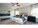 Spacious bedroom with a queen-size bed, matching nightstands and dresser with carpet flooring at 655 Blackshear Trl, Temple, GA 30179