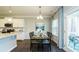 Dining area featuring a table set for four, complemented by stylish curtains and a view of the outdoor patio at 655 Blackshear Trl, Temple, GA 30179