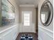 Inviting foyer with decorative wainscoting, art and a round mirror that leads into other areas of the house at 655 Blackshear Trl, Temple, GA 30179