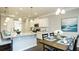Open kitchen featuring a large island, dining table, and modern appliances, perfect for entertaining and Gathering gatherings at 655 Blackshear Trl, Temple, GA 30179