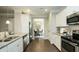 Well-lit kitchen featuring stainless steel appliances, white cabinets, and an open view into the dining area at 655 Blackshear Trl, Temple, GA 30179