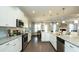 Modern kitchen featuring granite countertops, stainless steel appliances, and an open layout leading to the dining area at 655 Blackshear Trl, Temple, GA 30179