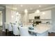 Bright kitchen with a large granite island, pendant lighting, stainless steel appliances, and white cabinetry at 655 Blackshear Trl, Temple, GA 30179