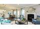 Open-concept living room featuring a fireplace, dining area, and views into other living spaces at 655 Blackshear Trl, Temple, GA 30179