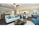 Open-concept living room with a modern sofa, accent chair, stylish coffee table, and seamless transition to the kitchen at 655 Blackshear Trl, Temple, GA 30179
