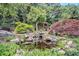 Beautiful backyard with a custom koi pond, waterfall feature, and gazebo with wooded views at 130 Honey Ln, Fayetteville, GA 30214