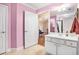 Bathroom with pink walls, a single sink vanity, and tiled floors at 130 Honey Ln, Fayetteville, GA 30214