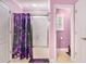 Bathroom with pink walls and a glass enclosed tub at 130 Honey Ln, Fayetteville, GA 30214