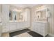 Bright bathroom featuring double sinks, white cabinetry, ample storage and neutral accents at 130 Honey Ln, Fayetteville, GA 30214