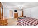 Bedroom with a plaid bedspread, wood dresser, and TV at 130 Honey Ln, Fayetteville, GA 30214