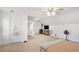 Large bonus room with neutral carpet, ceiling fan, and entrance to a bathroom at 130 Honey Ln, Fayetteville, GA 30214