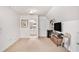 Spacious bonus room featuring neutral carpet, a TV, and an entrance to a bathroom at 130 Honey Ln, Fayetteville, GA 30214