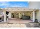 Backyard patio with stone columns, hot tub, and TV with string lights at 130 Honey Ln, Fayetteville, GA 30214