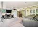 Covered outdoor patio featuring a fireplace, TV, and a relaxing hot tub at 130 Honey Ln, Fayetteville, GA 30214