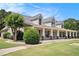 Side view of a lovely one-story home with a long, covered front porch and manicured landscaping at 130 Honey Ln, Fayetteville, GA 30214