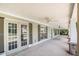 Covered front porch with stone columns, multiple entry doors, and ceiling fans at 130 Honey Ln, Fayetteville, GA 30214