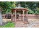 Wooden gazebo in a lush backyard setting with mature trees and landscaping at 130 Honey Ln, Fayetteville, GA 30214