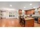 Open kitchen featuring an island with seating, stainless steel appliances and wood flooring at 130 Honey Ln, Fayetteville, GA 30214