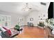 Open living room featuring hardwood floors, a fireplace, and a ceiling fan at 130 Honey Ln, Fayetteville, GA 30214