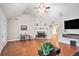Inviting living room with a stone fireplace, vaulted ceilings, and hardwood flooring at 130 Honey Ln, Fayetteville, GA 30214