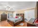 Primary bedroom featuring hardwood floors, fan and ample natural light from French doors at 130 Honey Ln, Fayetteville, GA 30214